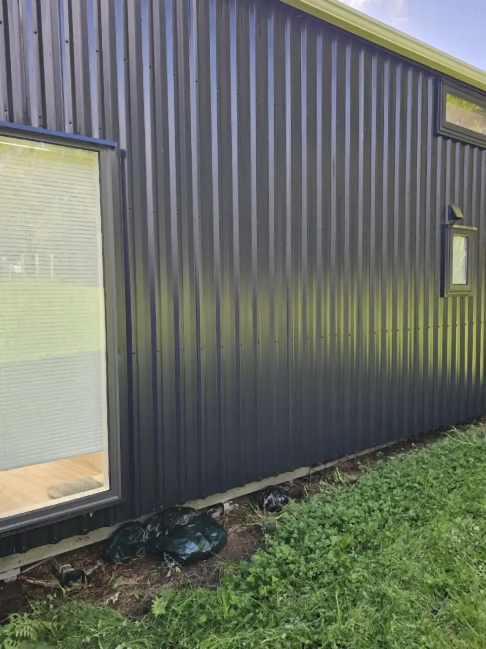 After: The same cladding clean and dark again