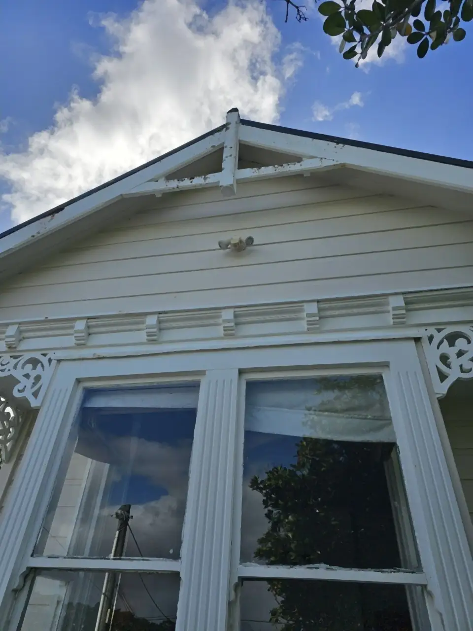 After: The same bay window and gable clean and white